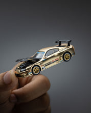 POP RACE 1:64 TOP SECRET GT300 SUPRA CHROME GOLD / CARBON HOOD